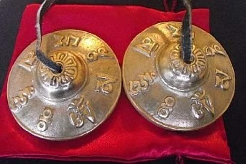Tibetan Buddhist Hand Bells embossed with the Mantra of the Buddha of Compassion 'OM MANI PADME HUM' ;Hail to the Jewel in the Heart of the Lotus; 65cm Diameter. Comes in a Red Satin Drawnstring Carry Pouch - sold by Spiritual Gifts. Usually dispatched within 2 working days.