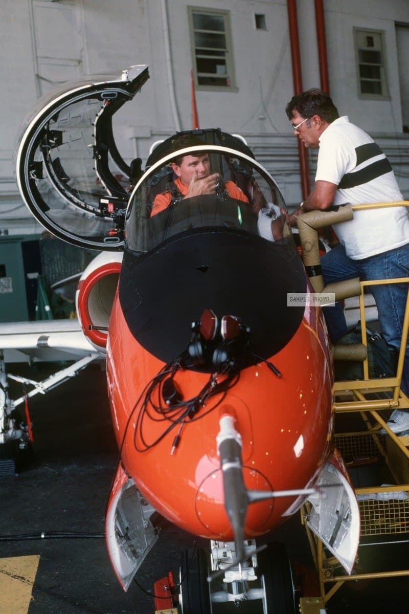 Photo Sitting in the cockpit of a T-45A Goshawk aircraft, a pilot discusses an impending evaluation flight with a technician. The Navy intends to replace its fleet of TA-4J Skyhawk and T-2C Buckeye trainer aircraft with about 300 Goshawks. The T-45A, which is capable of landing aboard aircraft carriers, will be used for intermediate and advanced student pilot training, 07/01/1989