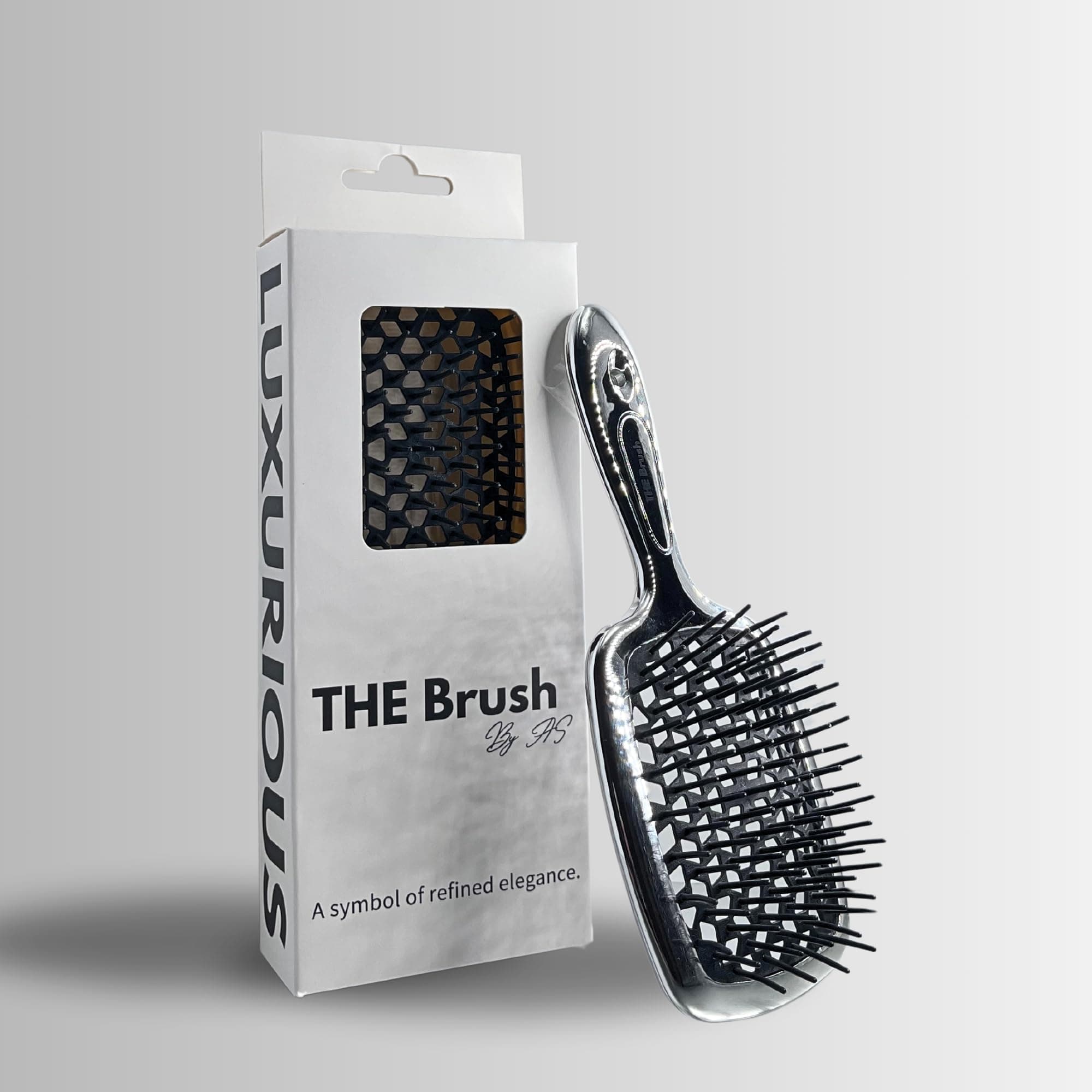 THE Brush hairbrush is your ultimate luxury detangling superbrush, available in chrome gold and silver. With versatile bristles for all hair types, wet or dry, this professional tool gently massages