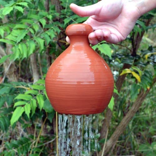 Terracotta thumb pot waterer